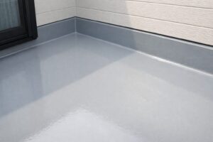 FRP防水で施工されたベランダ床の防水層。立ち上がりまで一体化した継ぎ目のない防水構造