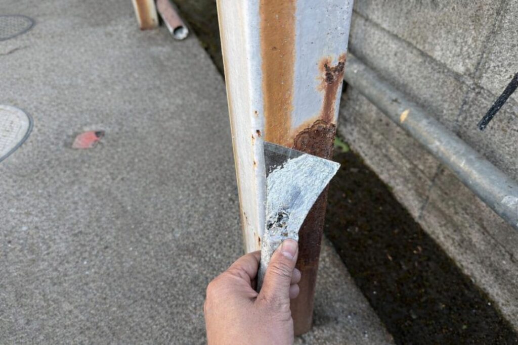 練馬区の集合住宅で鉄骨柱の錆を皮スキで除去するケレン作業
